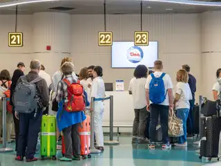 Tourists queue at the new seaplane check-in area