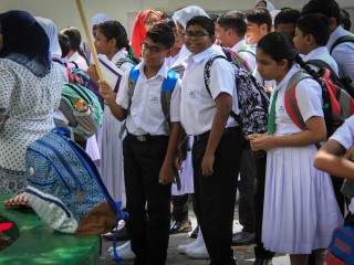Students at the Kalaafaanu School standing before an assembly