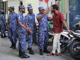 An officer of the police's Special Operations unit instructing a civilian 