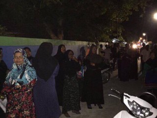 April 6, 2016: people gather outside police station in Maamigilli, protesting the arrest of Qasim Ibrahim