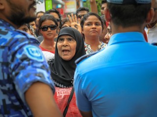 Abducted journalist Ahmed Rilwan\'s mother Aminath Easa, confronting police officers ordered to block a march calling for justice in her son\'s abduction