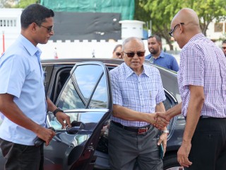 Former President Maumoon Abdul Gayoom (C) greeted as he exits his vehicle