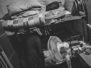 Photograph showing a family of four living in a one-room space in capital city Malé