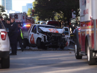 First responders are pictured surrounding the Home Depot rental truck that was used in the attack in Lower Manhattan on Oct. 31, 2017