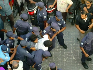 Police forcefully arrest two at rally
