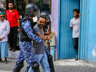A protester being led away by police