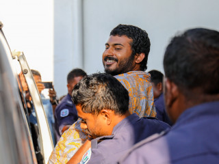 Police escort journalist Mohamed Wisam