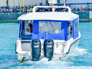 Former President Maumoon Abdul Gayoom looks onto supporters as he is escorted in a police vessel