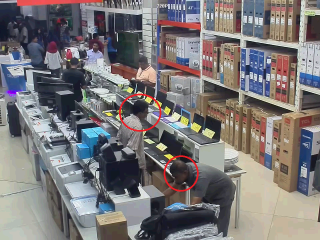 CCTV footage shows the thieves standing near the laptops before hiding them under their shirts and leaving