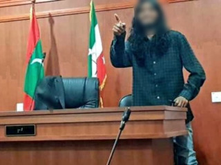 A young man poses at the judge\'s bench