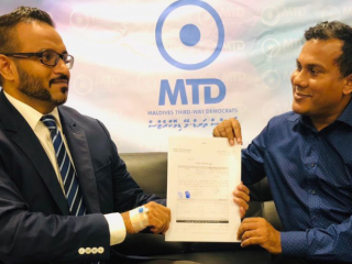 Adeeb hands over his membership application to MTD leader Ismail Asif