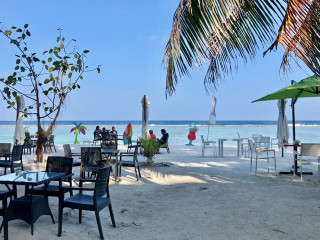 Café and restaurants in Hulhumalé’s beach front have tables set out on the beach