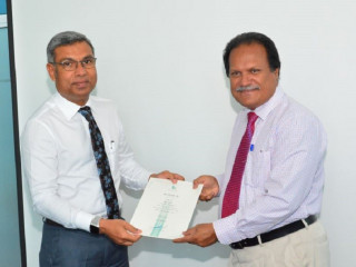 Mohamed Saeed (l) receives his letter of appointment