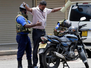 Sri Lankan police check a driver