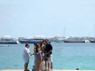 This photograph, taken on August 1, 2016, shows a group of tourists taking selfies in Hulhumale'.