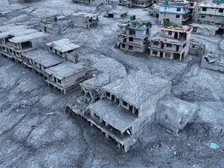 An aerial photograph shows debris and mud engulfing homes and residential areas in the village of Devghat, Nepal, following a devastating flash flood on August 29, 2026.