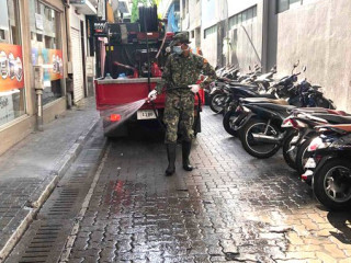 MNDF officer disinfecting Male\' City roads
