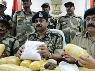 India’s Border Security Force (BSF) Deputy Inspector General (DIG) M.F. Farooqui and fellow officers pose with 11 kilograms of heroin seized near the Indo-Pakistani border. This photograph was taken on September 2, 2013.