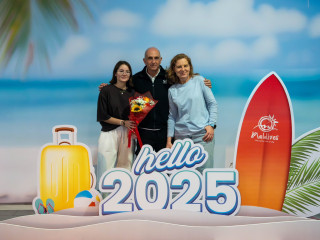 The first tourist and his family being welcomed at the airport in early January