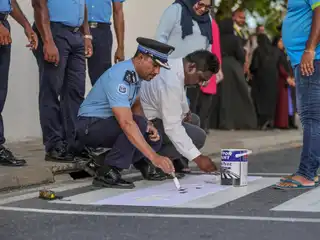As part of a campaign conducted to raise public awareness regarding road safety and to foster the habit of crossing streets safely.