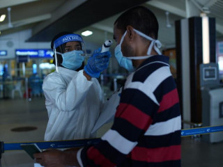 Healthcare worker screening individual at VIA