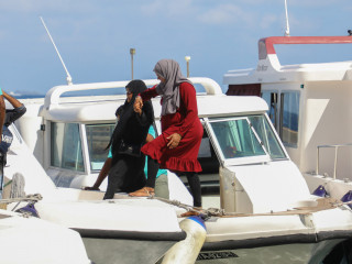 Individuals departing from the capital via boat