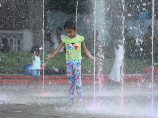 A child plays inside the fountain at Republic Square