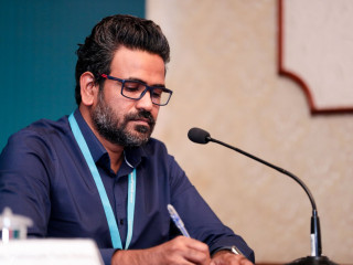 Dr. Moosa Hussain at an NEOC press briefing
