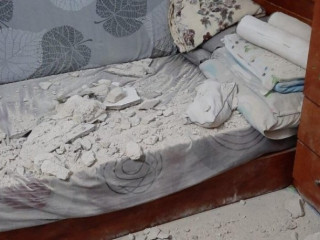 The photo of the incident shows that part of the wall had fallen onto the bed