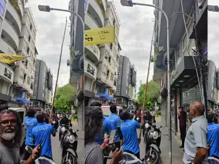 City council workers take down banners put up for the massive MDP demonstration scheduled for October 3.