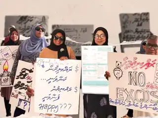 Residents of N. Velidhoo hold a protest near the island's Fenaka office.
