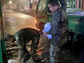 MNDF officers working to place sandbags near entrances of homes and shops due to flooding in Malé on Saturday
