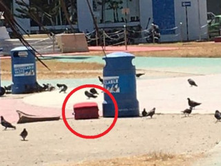 Red suitcase abandoned at Republic Square in the capital city