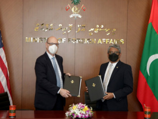 Minister of State for Foreign Affairs Ahmed Khaleel and USAID Mission Director Reed Aeschliman  