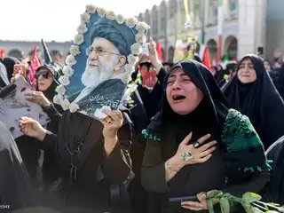 A woman grieves among the crowds gathered at the Imam Khomeini Grand Mosque in Tehran, Iran, on July 4, 2026, during a funeral ceremony to pay final respects to the country's late Supreme Leader, Ayatollah Ali Khamenei.