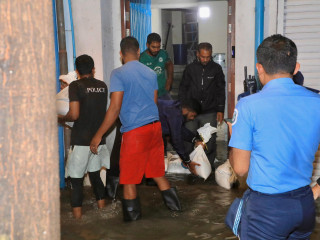 The public and authorities work to place sandbags due to heavy flooding in Malé City
