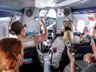 Tourists travel to a Maldivian resort aboard a Trans Maldivian Airways (TMA) aircraft.