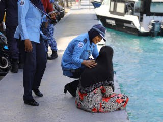 Police officer talking to distressed woman