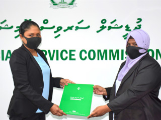 Fathimath Faruheeza being presented her letter of appointment.