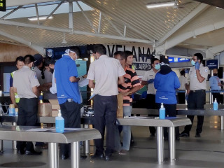 (File photo) Individuals drop off packages to be delivered to family members stranded aborad.