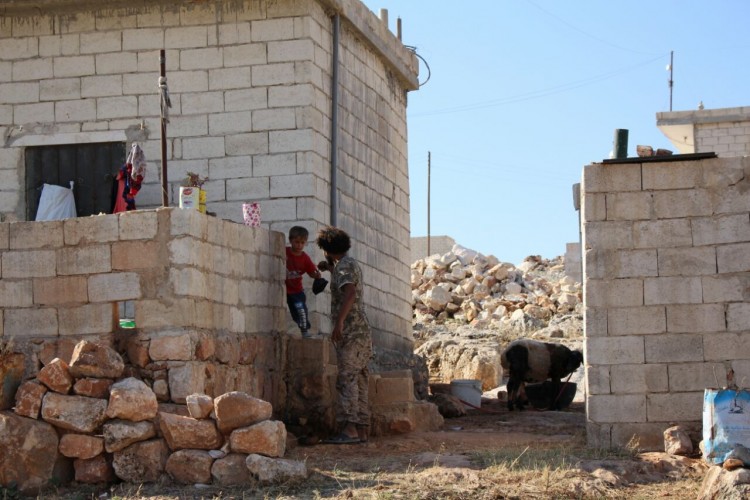 A young boy collects a bag of food from a combatant while on a distribution round