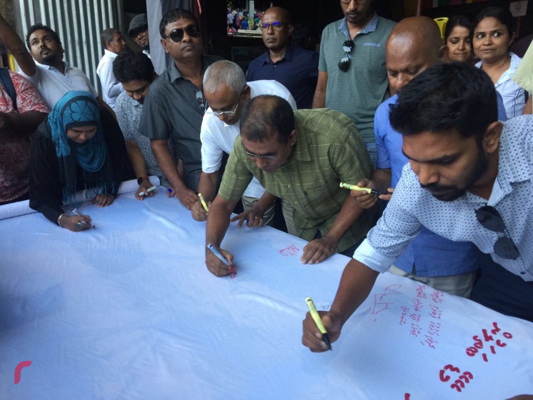 ޖެނުއަރީ 23، 2018: ގުޅިފައިވާ އިއްތިހާދުން އިންތިޒާމްކޮށްގެން އެމްޑީޕީ ހަރުގެ ސަރަހައްދުގައި ކުރިއަށްގެންދިޔަ ހަރަކާތުގައި "މޭޑޭގެ ބަތޮލުންގެ ފޮތިގަނޑު" ގެ ނަމުގައި ފޮތިގަނޑެއްގައި ސޮއި ކުރަނީ