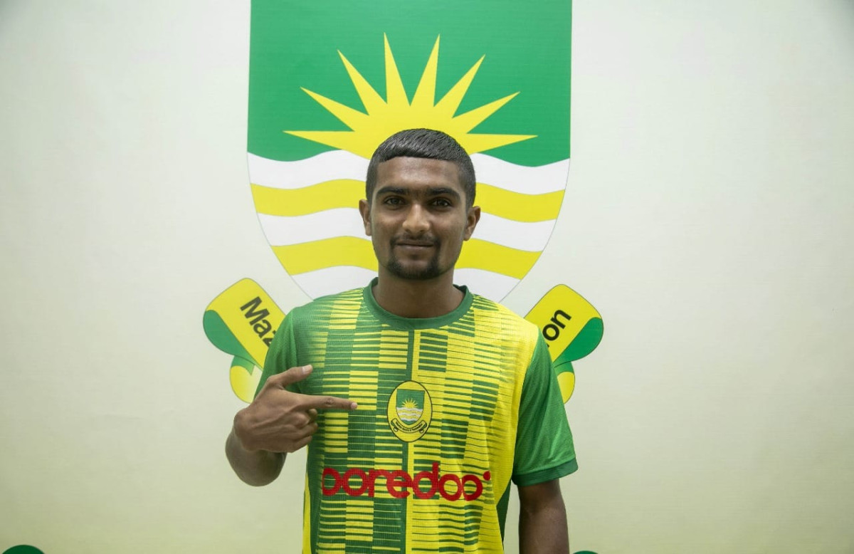 Aiham Maziya flaunts his jersey after the signing