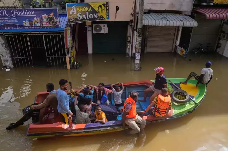 ސްރީލަންކާ ގެ ކޮލަމްބޯ ގައި ފެން ބޮޑުވެފައިވާ ސަރަހައްދެއް ގައި ތިބި މީހުން ސަލާމަތް ކުރުމަށް މީހުން ހަރަކާތްތެރި ވަނީ - ފޮޓޯ: އޭޕީ