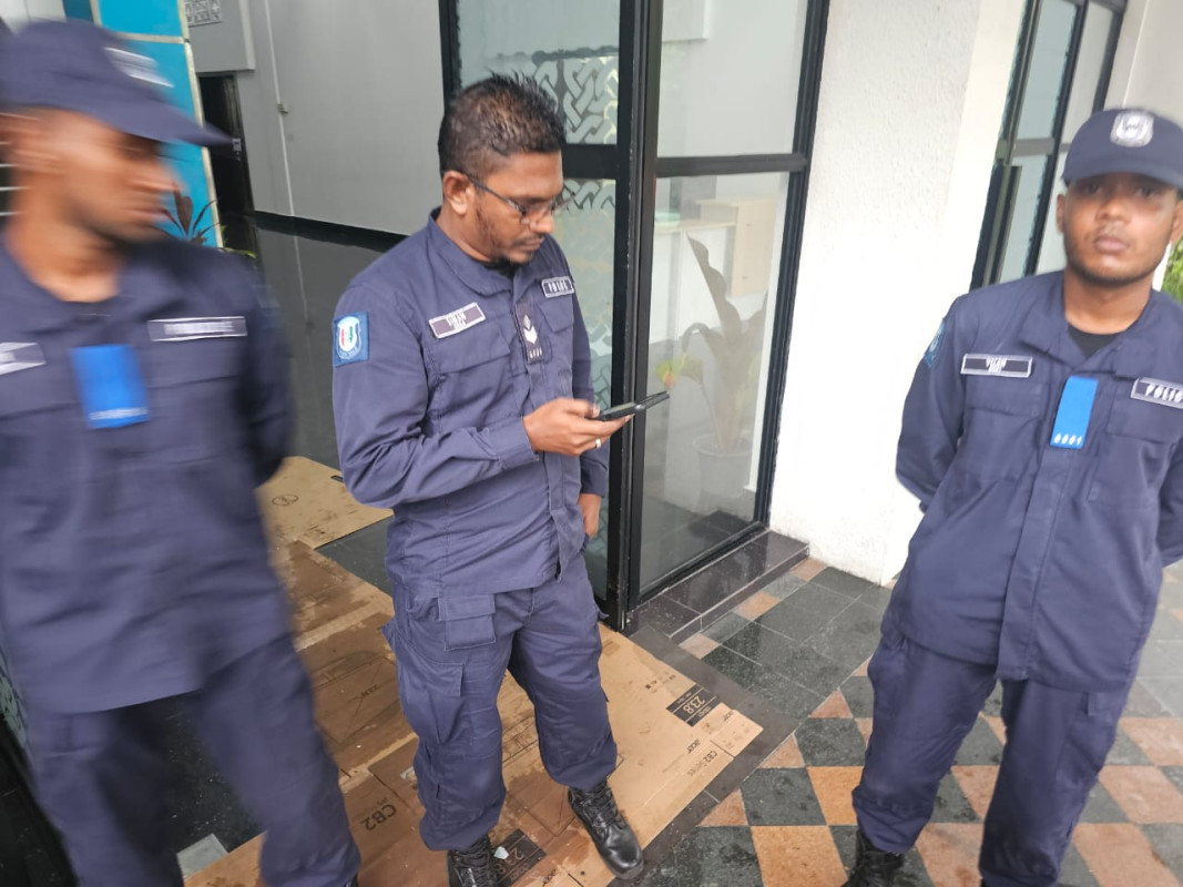 Police officers standing at the entrance of Dharubaaruge