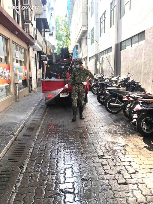 MNDF officer disinfecting Male\' City roads