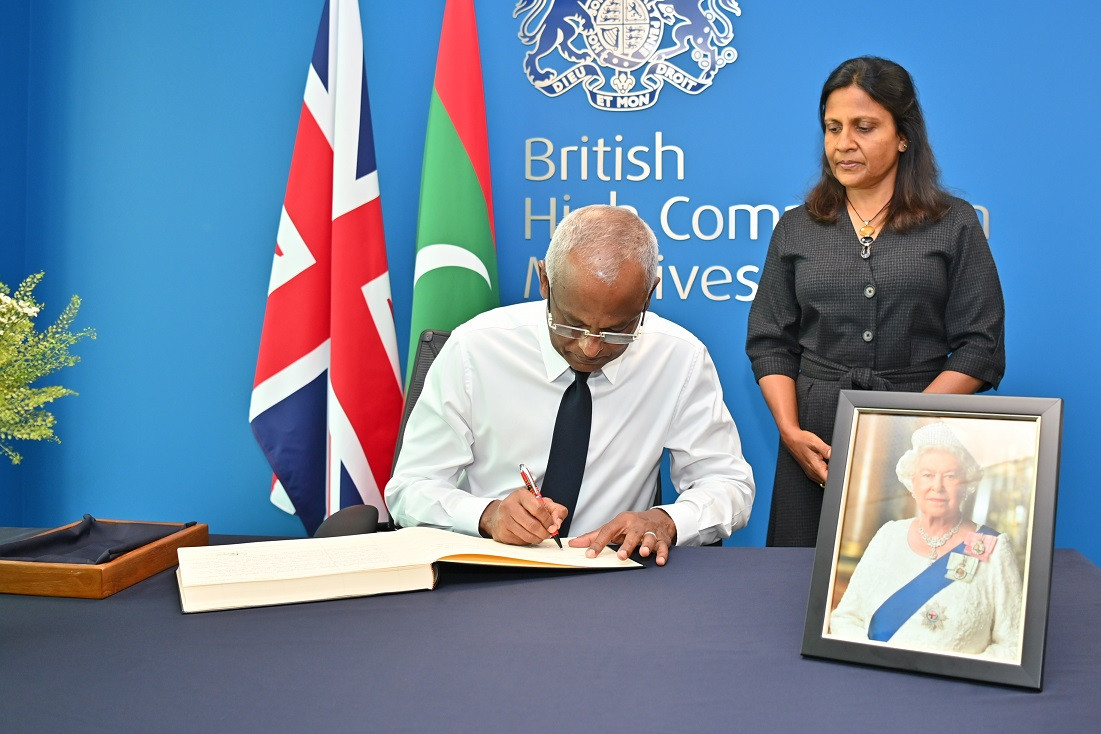 The President and First Lady sign the book of condolence in memory of the late Queen Elizabeth II