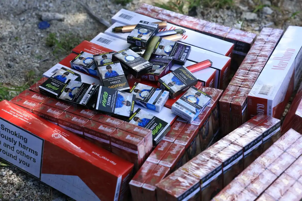 Police begin destruction of confiscated cigarettes.