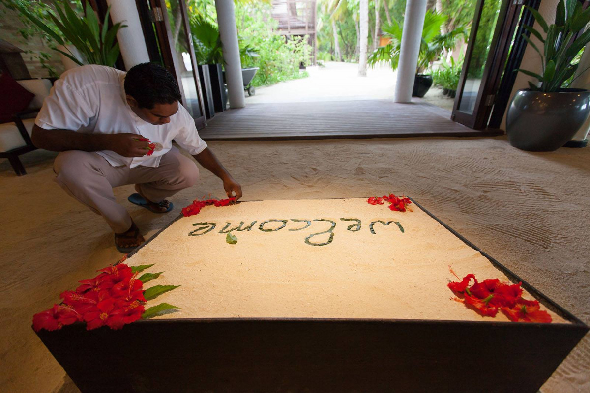 Resort worker decorating the lobby to welcome arrivals