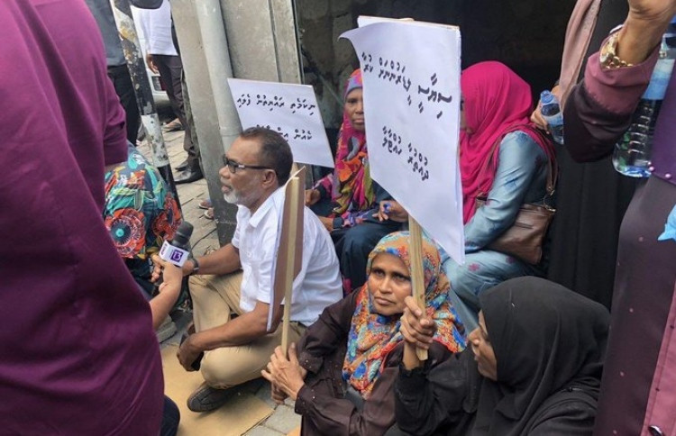 Abdul Raheem Abdulla amid protesters during an earlier rally